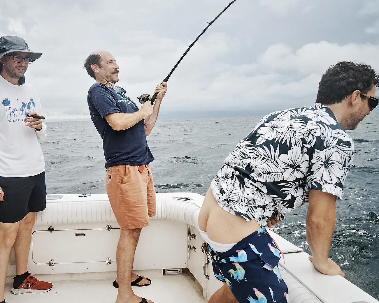 Comedian Ari Shaffir fishing on a fishing boat with comedians Mark Normand and Joe List of Tuesdays with Stories, with Mark showing his butt crack. Find more Tuesdays with Stories photos at www.tuesdayspod.com/photos