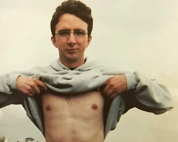 Comedian Joe List of Tuesdays with Stories shirtless by a cliff. Find more about Joe at www.tuesdayspod.com/joe-list