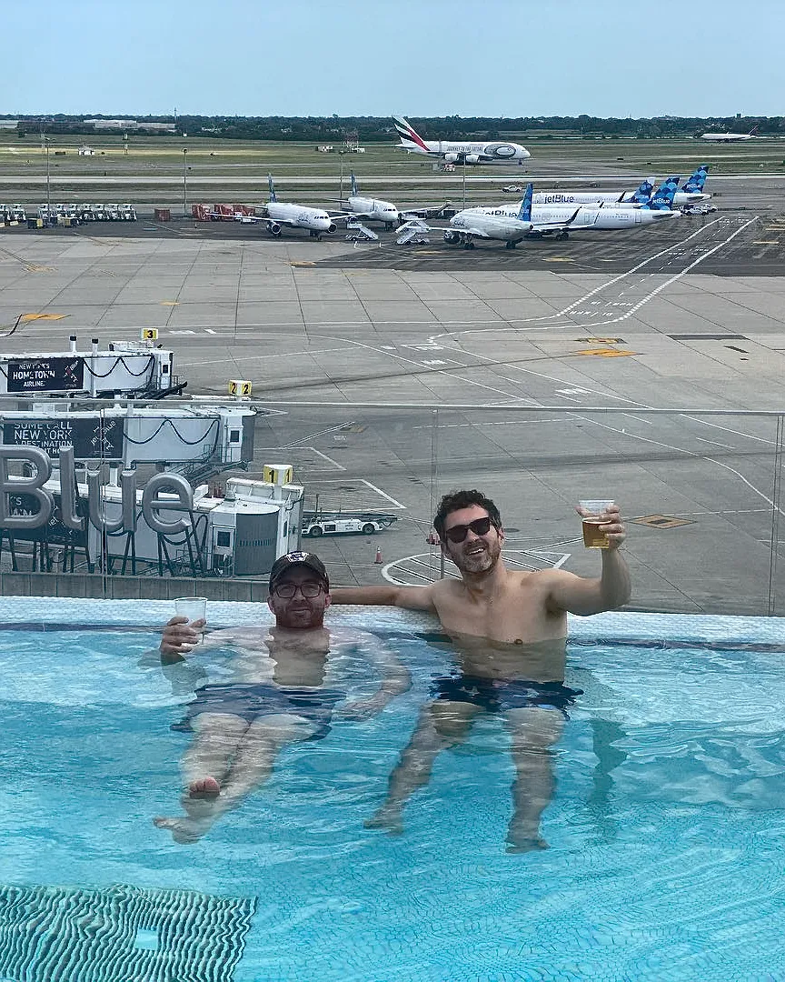 Comedians Mark Normand and Joe List of Tuesdays with Stories at an airport hotel outdoor pool. Find Mark Normand Tour Dates and Joe List Tour Dates at www.tuesdayspod.com/find-a-show