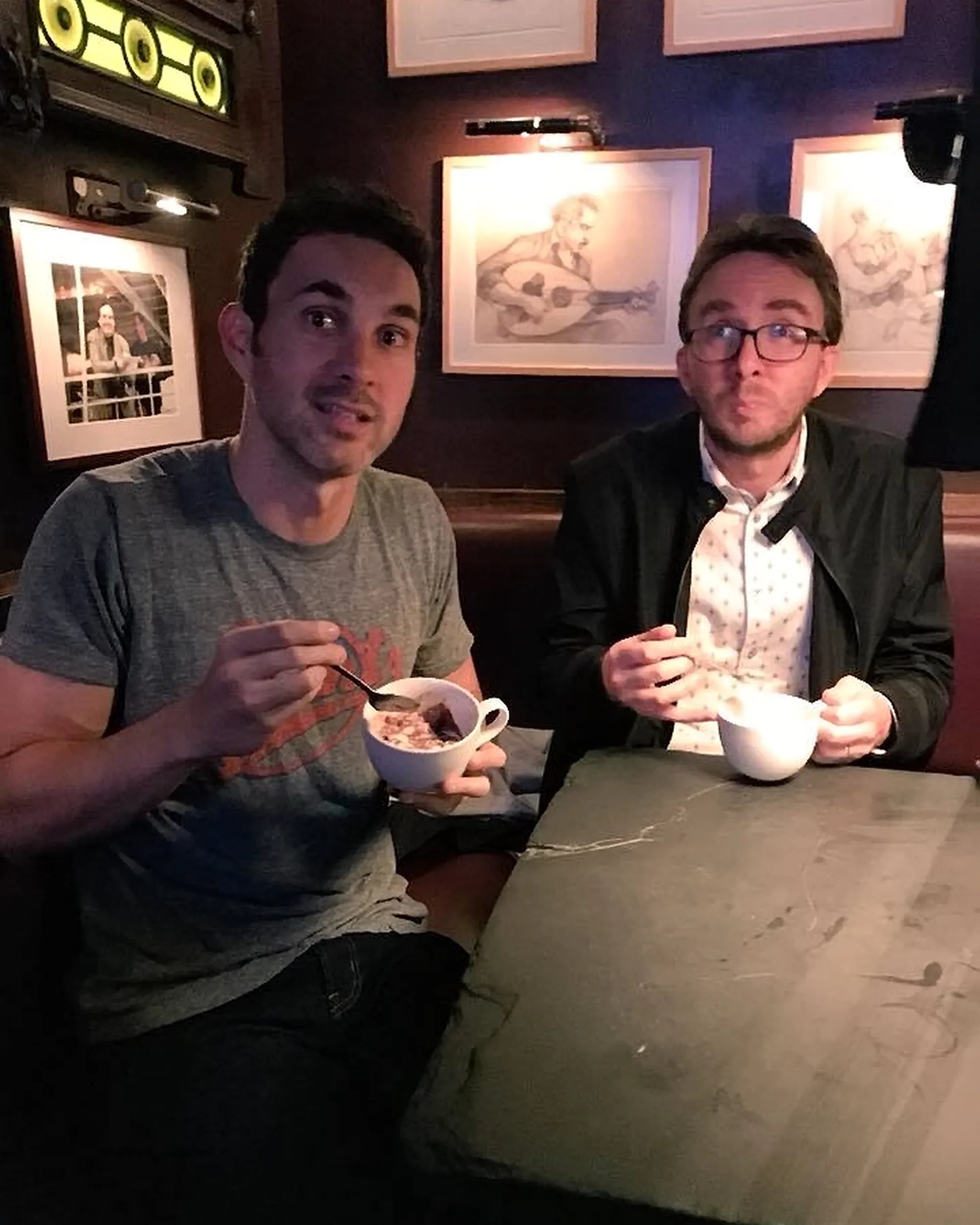Comedians Mark Normand and Joe List of Tuesdays with Stories eating ice cream in the comedy club. Find Mark Normand Tour Dates and Joe List Tour Dates at www.tuesdayspod.com/find-a-show