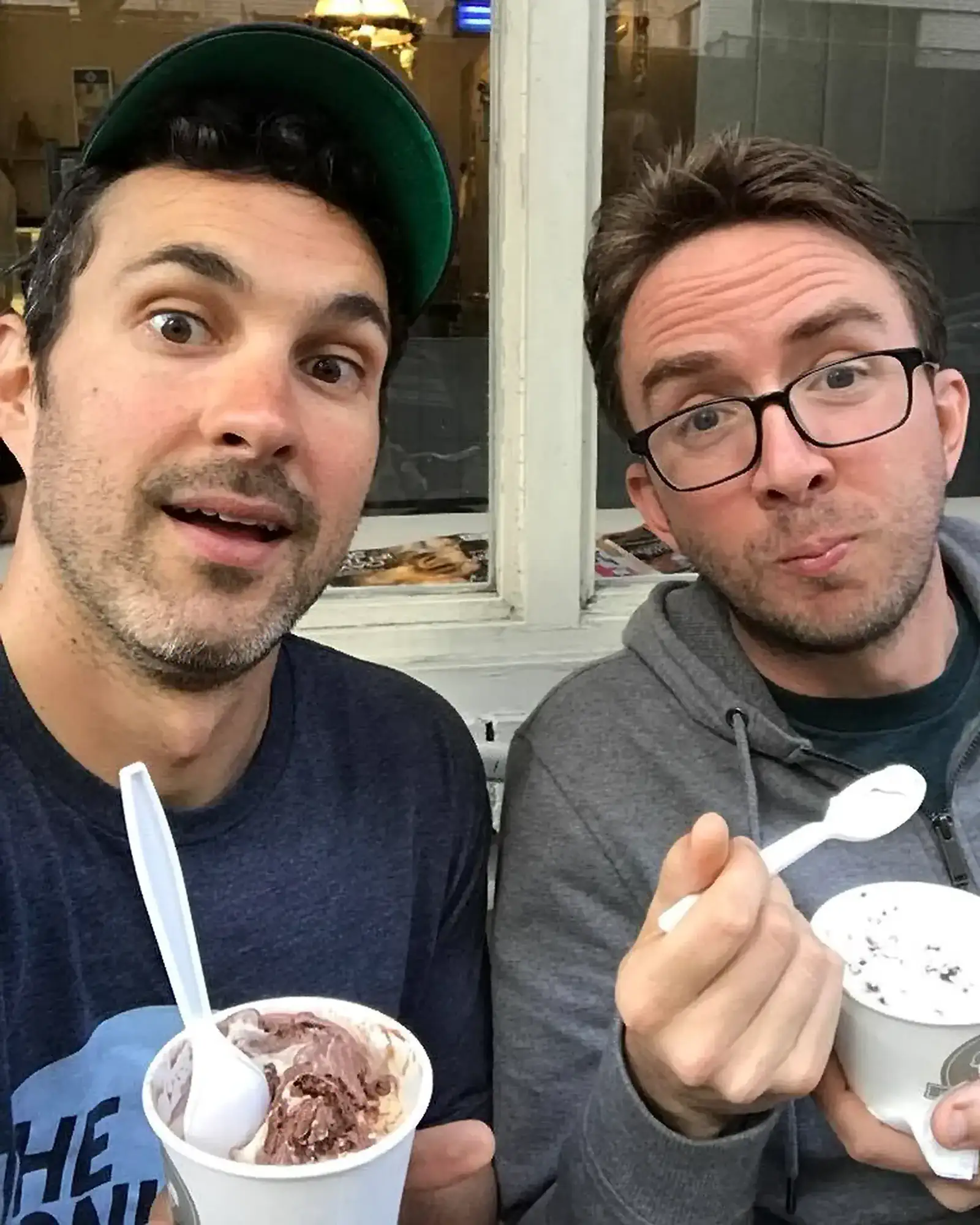 Comedians Mark Normand and Joe List of Tuesdays with Stories taking a selfie while eating ice cream. Find Mark Normand Tour Dates and Joe List Tour Dates at www.tuesdayspod.com/find-a-show