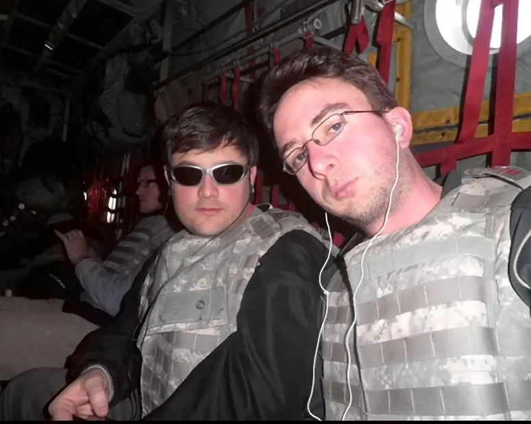 Comedian Joe List of Tuesdays with Stories with comedian Nate Bargatze on a military comedy tour, in a US Army plane, in bullet proof camo vests. Find more about at www.tuesdayspod.com/joe-list